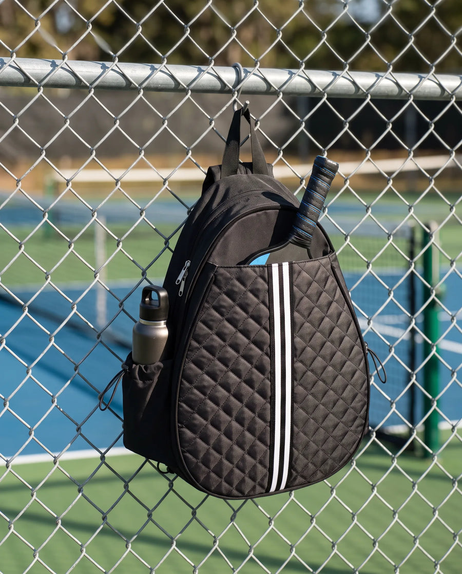 Quilted Court Sling hanging on a court fence